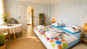 Sleeping area in the Panorama Studio with two beds and a view into the hallway