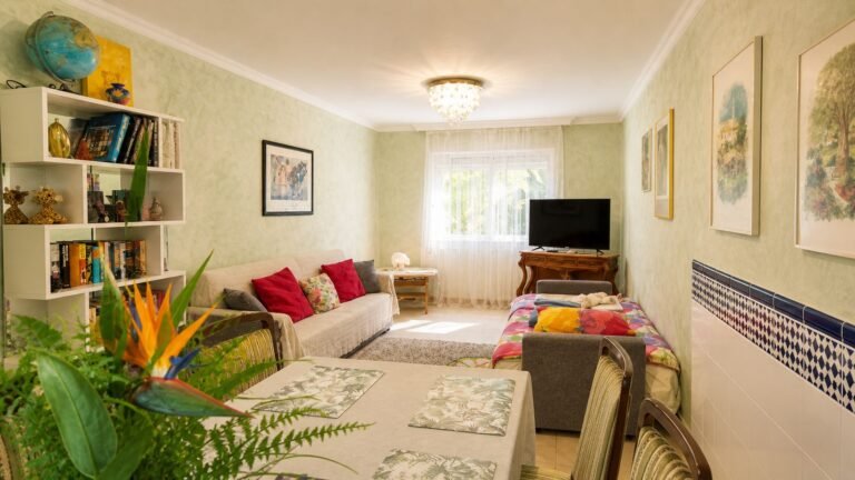 Living and dining area of the Family Apartment with sofa, dining table and additional bed